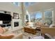 Bright living room features tall ceilings, fireplace, and large windows with neighborhood views at 10259 Fairgate Way, Highlands Ranch, CO 80126