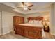 Comfortable main bedroom with wooden furniture, a ceiling fan, and soft carpet flooring at 10259 Fairgate Way, Highlands Ranch, CO 80126