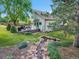 Backyard showcasing a water feature, lush landscaping, and a spacious deck at 1052 Northampton Ct, Highlands Ranch, CO 80126