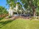 Large backyard featuring a spacious deck, lush lawn, and mature trees at 1052 Northampton Ct, Highlands Ranch, CO 80126