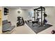Home gym with weight training area and accent chair at 1052 Northampton Ct, Highlands Ranch, CO 80126