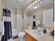 Cozy full bathroom features a shower-tub combo and updated vanity at 1052 Northampton Ct, Highlands Ranch, CO 80126