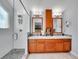 Well-lit bathroom with double vanity, modern fixtures, and tiled walk-in shower at 1052 Northampton Ct, Highlands Ranch, CO 80126