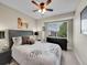 Comfortable bedroom features a ceiling fan, large window, and stylish furnishings at 1052 Northampton Ct, Highlands Ranch, CO 80126
