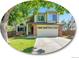 Charming two-story home with lush green lawn, mature trees, and two-car garage at 1052 Northampton Ct, Highlands Ranch, CO 80126