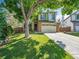 Charming two-story home with lush green lawn, mature trees, and two-car garage at 1052 Northampton Ct, Highlands Ranch, CO 80126