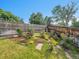 Charming garden area featuring colorful flowers, stone pathways, and a wooden fence at 1052 Northampton Ct, Highlands Ranch, CO 80126