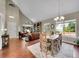 Open-concept living room with vaulted ceilings, hardwood floors, and abundant natural light at 1052 Northampton Ct, Highlands Ranch, CO 80126