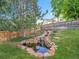 Backyard oasis featuring a serene pond, rock accents, and lush greenery at 1052 Northampton Ct, Highlands Ranch, CO 80126