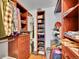 Organized walk-in closet with custom shelving, drawers, and ample storage space for clothes and accessories at 1052 Northampton Ct, Highlands Ranch, CO 80126