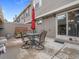 Enclosed back patio area with a stone table, seating, and privacy fencing at 7049 E Briarwood Cir, Centennial, CO 80112