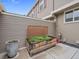 Back patio area with stone planter box and privacy fencing at 7049 E Briarwood Cir, Centennial, CO 80112