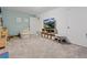 Playroom in the basement, including chairs, a television, storage, and neutral walls at 7049 E Briarwood Cir, Centennial, CO 80112