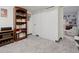 Finished basement with carpet, built-in bookcase, and closet at 7049 E Briarwood Cir, Centennial, CO 80112