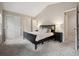 Bedroom featuring vaulted ceiling, closet space, and plush carpeting at 7049 E Briarwood Cir, Centennial, CO 80112