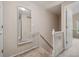 Upstairs hallway featuring updated railing and a full-length mirror at 7049 E Briarwood Cir, Centennial, CO 80112