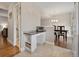 View of the kitchen featuring desk space and easy access to dining area and powder room at 7049 E Briarwood Cir, Centennial, CO 80112