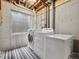 Unfinished laundry room in the basement with a washer, dryer, concrete walls, and a small window at 7049 E Briarwood Cir, Centennial, CO 80112