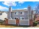 Backyard view of a gray home, featuring a fenced-in patio and well-maintained lawn at 7707 S Monaco Cir, Centennial, CO 80112