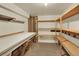 Unfinished basement area with exposed shelving and a workbench at 7707 S Monaco Cir, Centennial, CO 80112