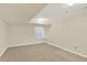 Finished basement area with window and neutral carpet at 7707 S Monaco Cir, Centennial, CO 80112