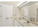 Bathroom featuring dual sinks, large mirror and neutral decor at 7707 S Monaco Cir, Centennial, CO 80112