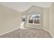 Bedroom featuring neutral carpet and large window with neighborhood view at 7707 S Monaco Cir, Centennial, CO 80112