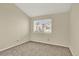 Bedroom featuring neutral carpet and window with neighborhood view at 7707 S Monaco Cir, Centennial, CO 80112