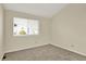 Bedroom featuring neutral carpet and window with neighborhood view at 7707 S Monaco Cir, Centennial, CO 80112