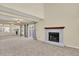 Large living room featuring a fireplace, carpeted floors, sliding glass doors, and a wall mirror at 7707 S Monaco Cir, Centennial, CO 80112