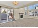 Bright living room featuring a fireplace, large windows, carpeted floors, and sliding glass door at 7707 S Monaco Cir, Centennial, CO 80112