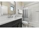 Bathroom featuring a vanity with a marble countertop, modern fixtures, and tub-shower combo at 428 Pontiac St, Denver, CO 80220