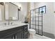 Chic bathroom featuring a shower with black grid door, vanity, and neutral decor at 428 Pontiac St, Denver, CO 80220