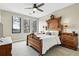 Bedroom showcasing a classic wooden bed frame and ample natural light from multiple windows at 428 Pontiac St, Denver, CO 80220