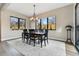 Bright dining room featuring modern chandelier, neutral walls and black framed windows at 428 Pontiac St, Denver, CO 80220