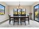 Dining area featuring wood table, modern chandelier, natural light, and stylish decor at 428 Pontiac St, Denver, CO 80220