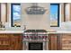 Close up of modern kitchen with stainless steel range, herringbone tile backsplash, and natural light at 428 Pontiac St, Denver, CO 80220