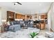 Open concept living area featuring a gray sectional, hardwood floors, and ample natural light at 428 Pontiac St, Denver, CO 80220
