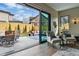 Open glass doors to the outdoor patio and backyard from inside the naturally lit living room at 428 Pontiac St, Denver, CO 80220