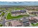 Expansive aerial view of a Primary-planned community featuring a school, green spaces, and various single-Gathering homes at 27625 E Moraine Dr, Aurora, CO 80016