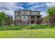 Beautiful home exterior showcasing a landscaped backyard with a stone firepit and patio at 27625 E Moraine Dr, Aurora, CO 80016