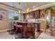 Finished basement bar area with seating, countertop, and storage at 27625 E Moraine Dr, Aurora, CO 80016