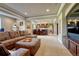 Basement entertainment space with large sofa, TV and views of a custom bar at 27625 E Moraine Dr, Aurora, CO 80016