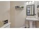 Tastefully decorated half-bathroom with a pedestal sink, modern fixtures, and stylish decor at 27625 E Moraine Dr, Aurora, CO 80016