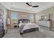 Inviting bedroom featuring plush carpet, tray ceilings, and stylish furnishings creating a cozy retreat at 27625 E Moraine Dr, Aurora, CO 80016