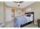 Relaxing bedroom featuring neutral walls, a ceiling fan, and an ensuite bathroom behind a white door at 27625 E Moraine Dr, Aurora, CO 80016