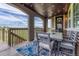 Covered outdoor deck with a dining set, string lights, and view of the neighborhood and open space at 27625 E Moraine Dr, Aurora, CO 80016