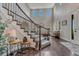 Inviting foyer featuring a staircase with elegant railings, hardwood floors, and a view into the living area at 27625 E Moraine Dr, Aurora, CO 80016
