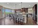 Kitchen featuring dark cabinets, granite countertops, stainless steel appliances, center island with barstools, and eat-in dining area at 27625 E Moraine Dr, Aurora, CO 80016