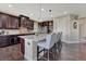 Kitchen featuring dark wood cabinets, stainless steel appliances, granite countertop, and center island with bar stool seating at 27625 E Moraine Dr, Aurora, CO 80016